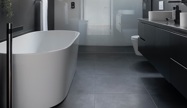 white ceramic bathtub near white bathtub